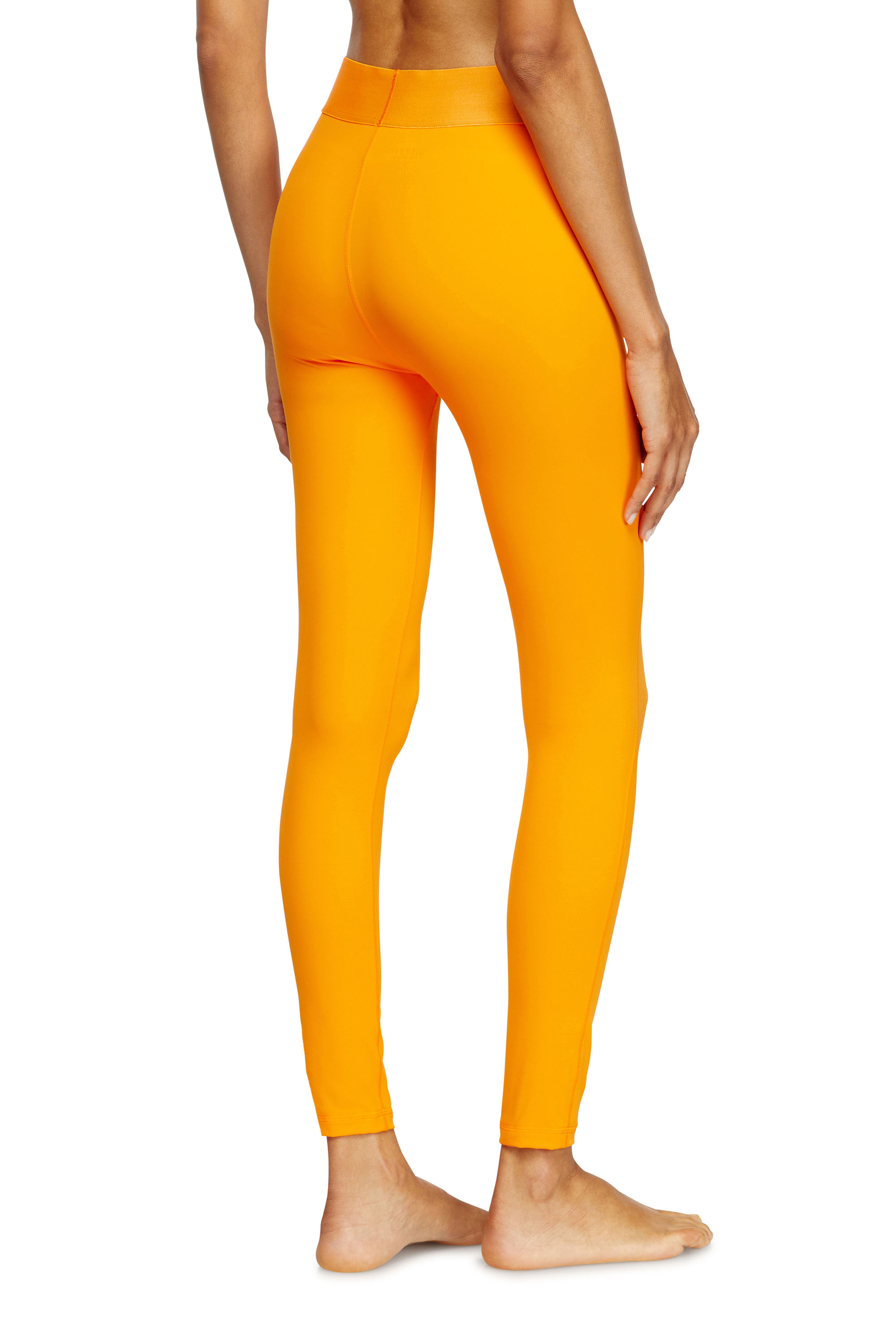 Diesel - ADELINE-D-POP, Leggings in microfibra con logo tagliato Donna in Arancione - 4